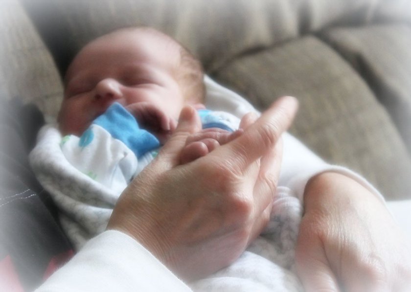 Holding hands with my new grandson